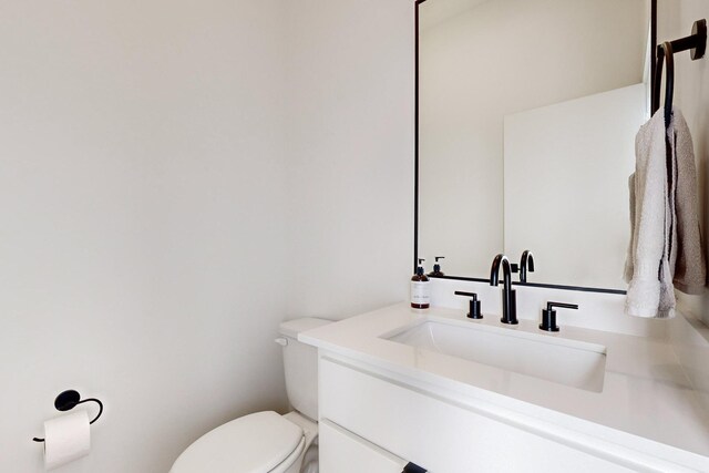 bathroom with toilet and vanity