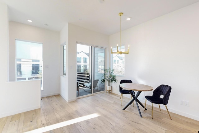 dining space featuring an inviting chandelier and light hardwood / wood-style floors