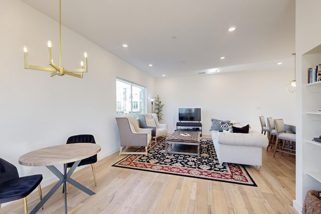 living room featuring light wood-type flooring and a notable chandelier