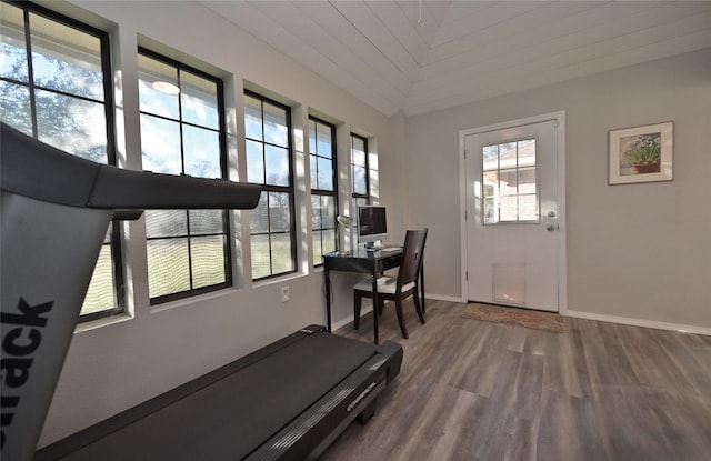 exercise room featuring lofted ceiling, wooden ceiling, and hardwood / wood-style floors