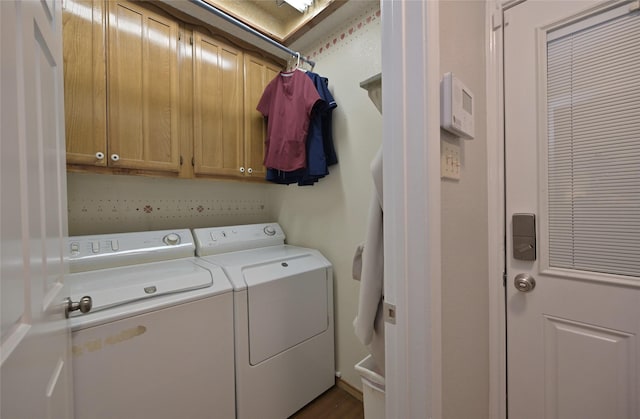 laundry room with washer and dryer and cabinets