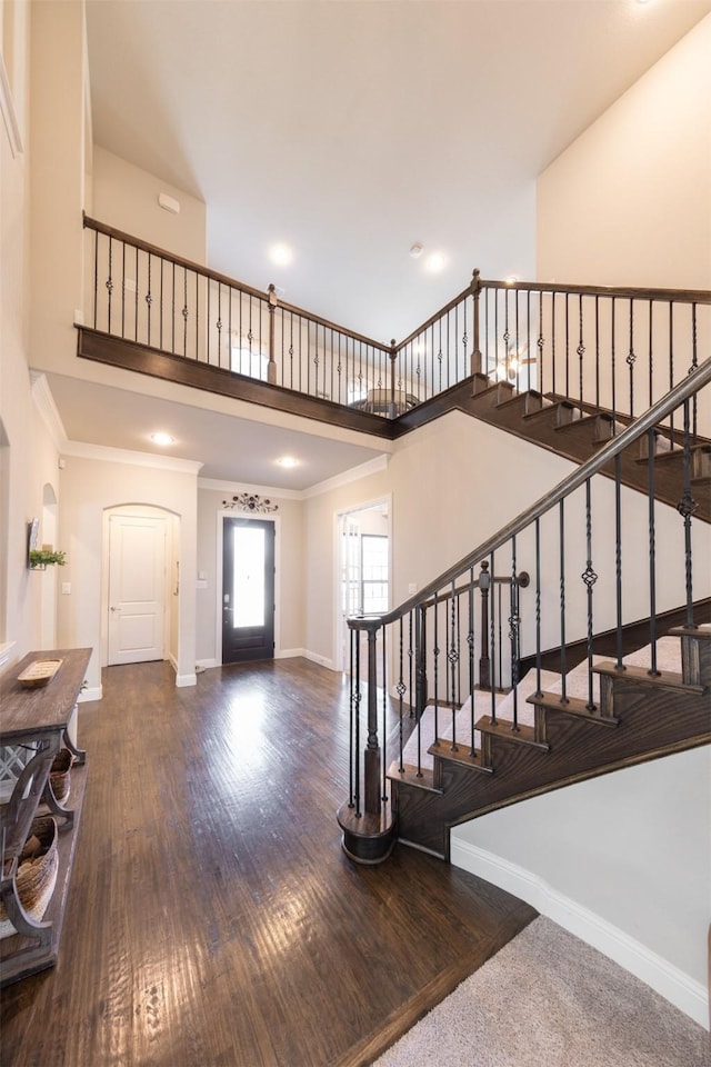 foyer featuring ornamental molding and dark hardwood / wood-style floors