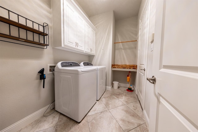 washroom featuring independent washer and dryer and cabinets