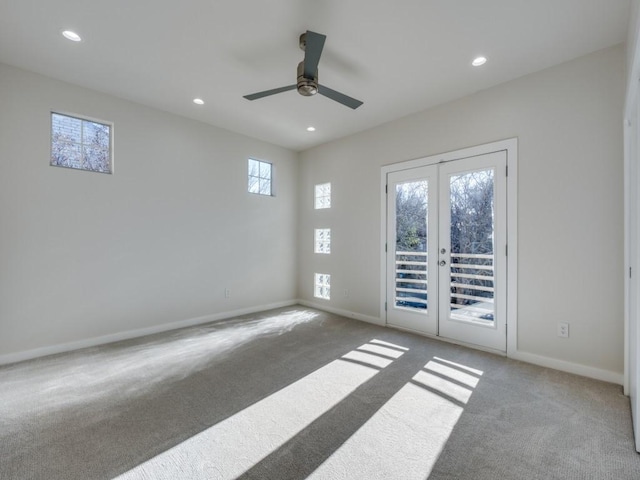 carpeted empty room featuring ceiling fan and french doors