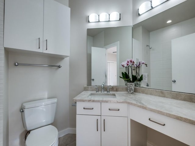 bathroom with toilet, vanity, tile patterned floors, and walk in shower