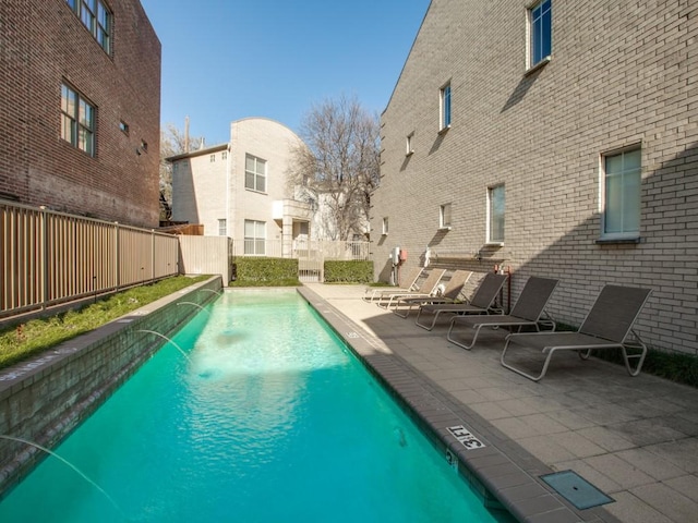 view of swimming pool with a patio and pool water feature