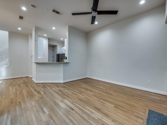 unfurnished living room with ceiling fan and light wood-type flooring