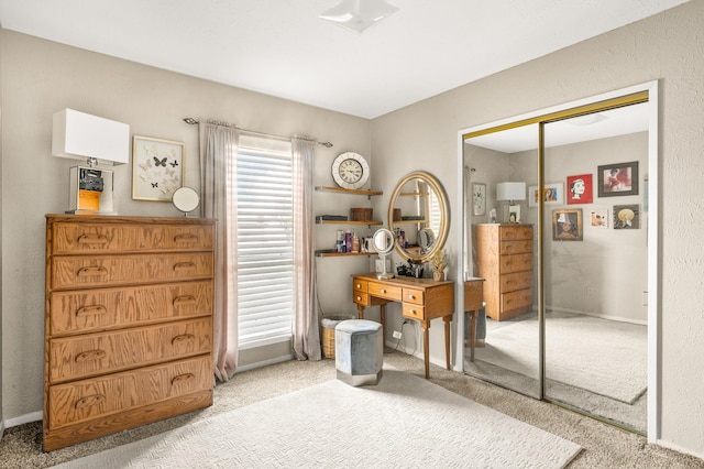 bedroom with a closet and light carpet