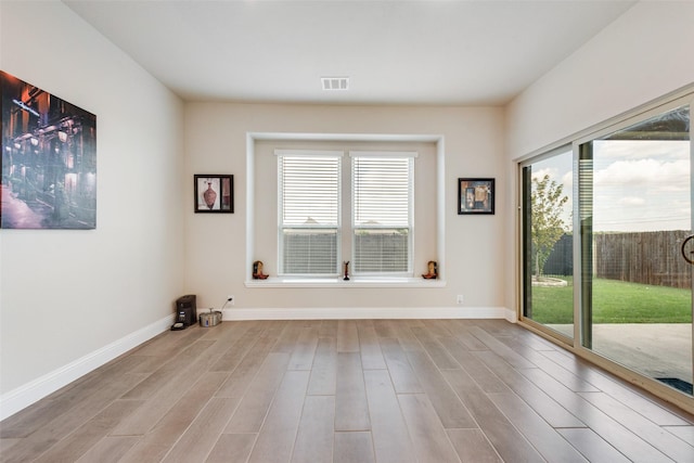 unfurnished room with light hardwood / wood-style floors