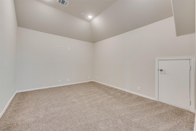 spare room featuring lofted ceiling and carpet