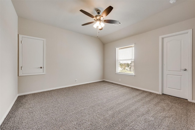 carpeted spare room with ceiling fan and lofted ceiling