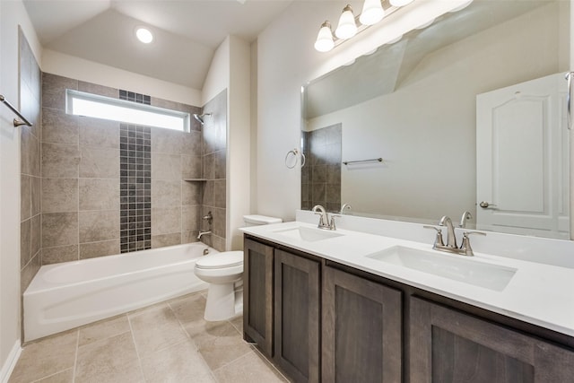 full bathroom featuring toilet, tile patterned flooring, lofted ceiling, tiled shower / bath combo, and vanity