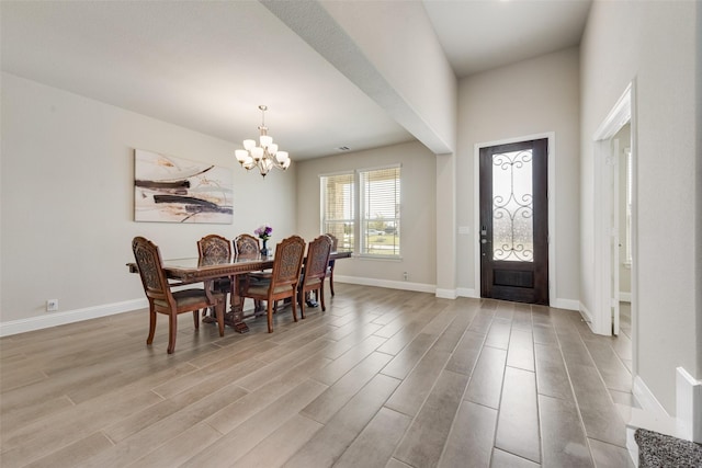 dining area featuring a chandelier and light hardwood / wood-style flooring