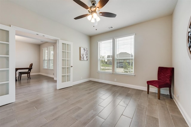 unfurnished room featuring light wood-type flooring, ceiling fan, and french doors