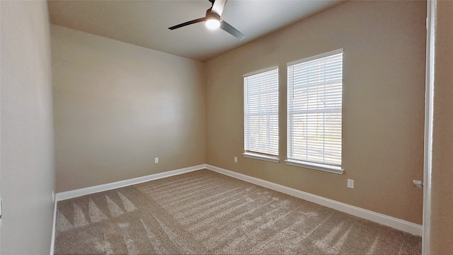 carpeted empty room featuring plenty of natural light and ceiling fan