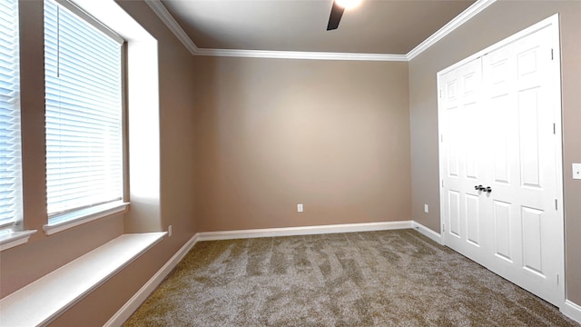 carpeted spare room with crown molding and ceiling fan