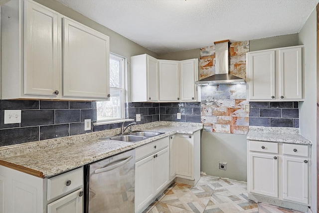 kitchen with sink, white cabinetry, wall chimney range hood, and stainless steel dishwasher