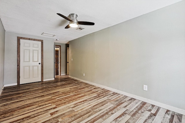 unfurnished bedroom with hardwood / wood-style floors, a textured ceiling, and ceiling fan