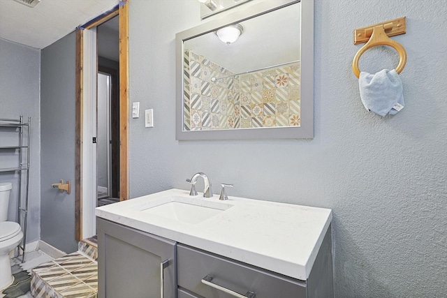 bathroom with toilet and vanity