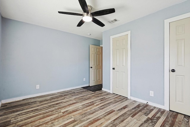 unfurnished bedroom featuring ceiling fan and hardwood / wood-style flooring