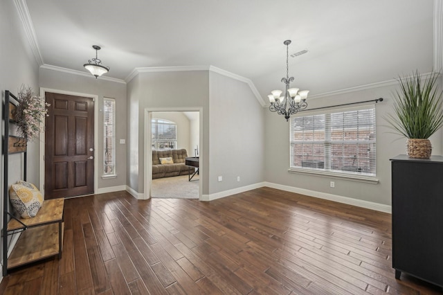 foyer with an inviting chandelier, crown molding, and dark hardwood / wood-style floors