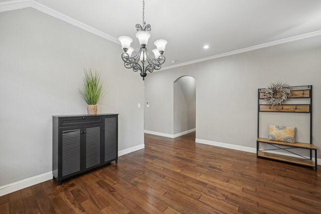 dining space featuring ornamental molding, an inviting chandelier, and dark hardwood / wood-style floors