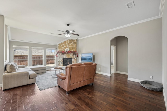 living room featuring a fireplace, ceiling fan, crown molding, and dark hardwood / wood-style flooring