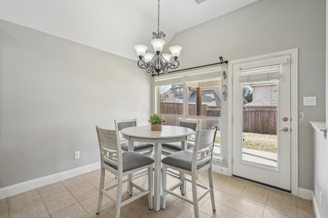 dining space featuring light tile patterned floors, vaulted ceiling, and a notable chandelier