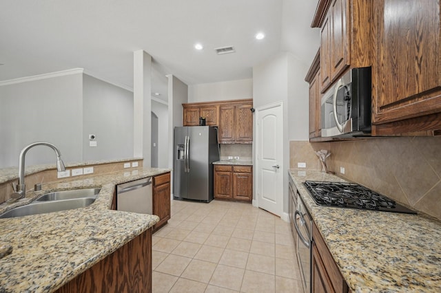 kitchen featuring sink, stainless steel appliances, light stone countertops, and light tile patterned floors