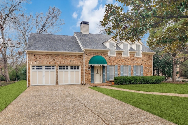 view of front facade with a garage and a front lawn