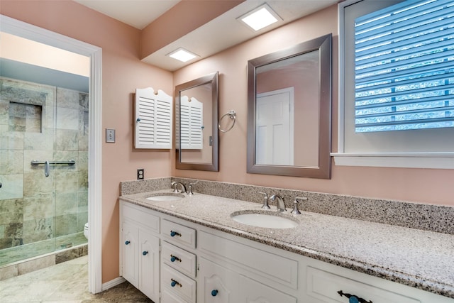 bathroom with vanity, an enclosed shower, and toilet