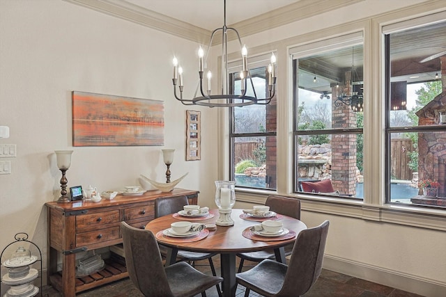 dining room with ornamental molding and a notable chandelier