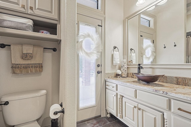 bathroom featuring toilet and vanity