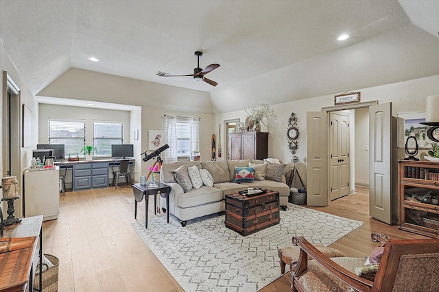 living room featuring lofted ceiling, light wood-type flooring, and ceiling fan