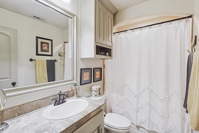 bathroom with toilet and vanity