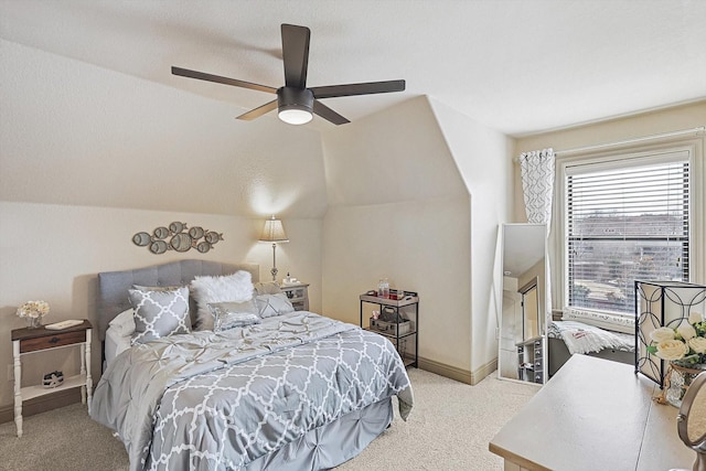 bedroom featuring vaulted ceiling, ceiling fan, and light carpet