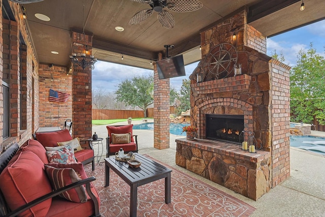 view of patio / terrace with a fenced in pool, an outdoor living space with a fireplace, and ceiling fan