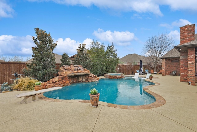 view of pool featuring a diving board, an in ground hot tub, and a patio