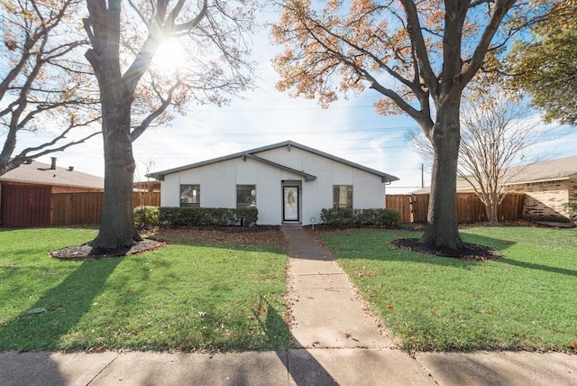 ranch-style home with a front lawn