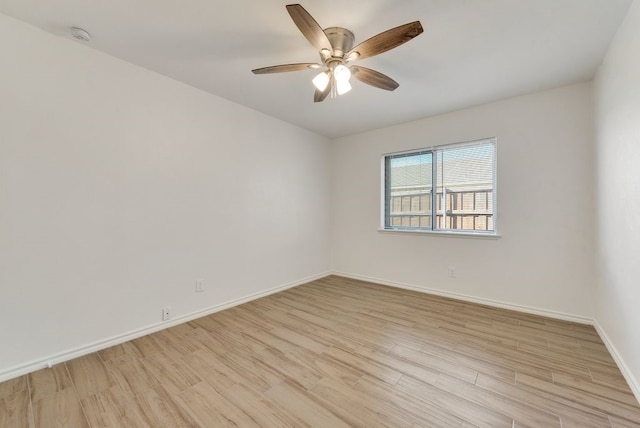 empty room featuring light wood-type flooring and ceiling fan