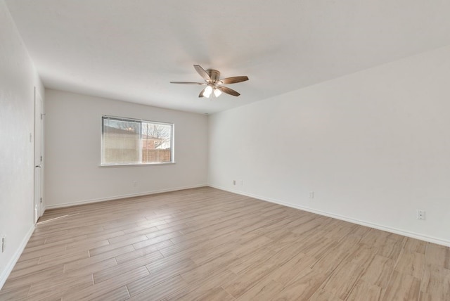 empty room with ceiling fan and light hardwood / wood-style floors