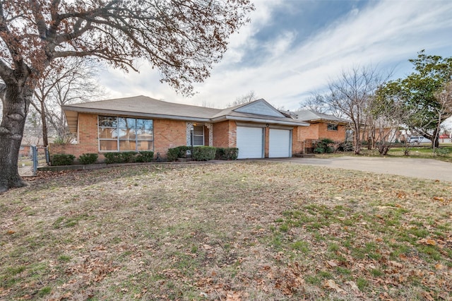 ranch-style house featuring a front yard and a garage