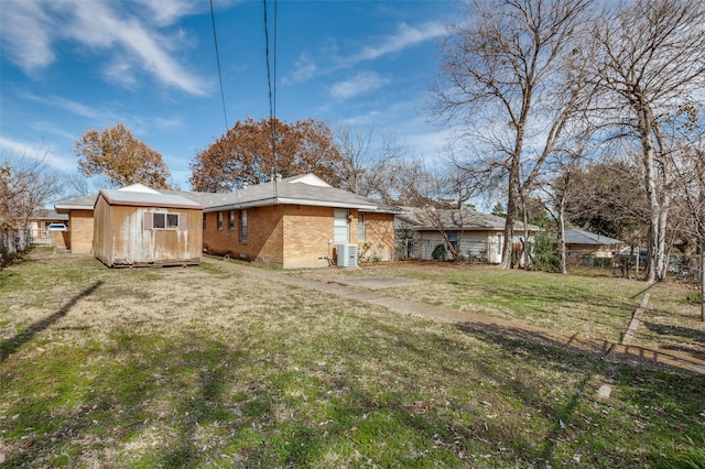 rear view of house with a yard and cooling unit