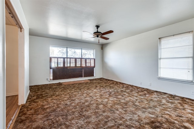 unfurnished room featuring ceiling fan and carpet