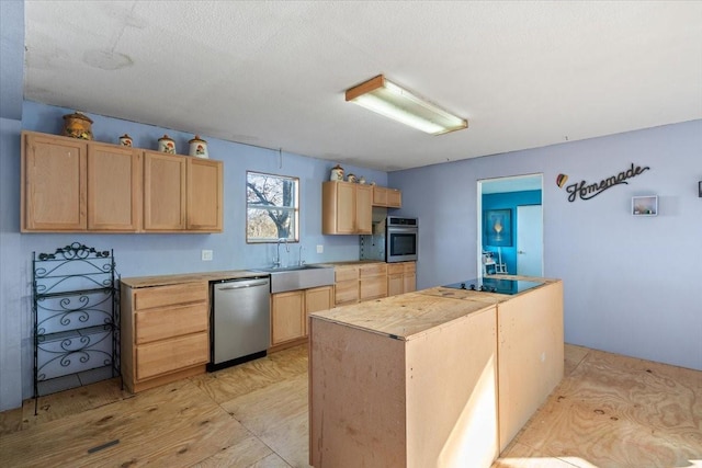 kitchen featuring stainless steel appliances, sink, a textured ceiling, and light brown cabinetry