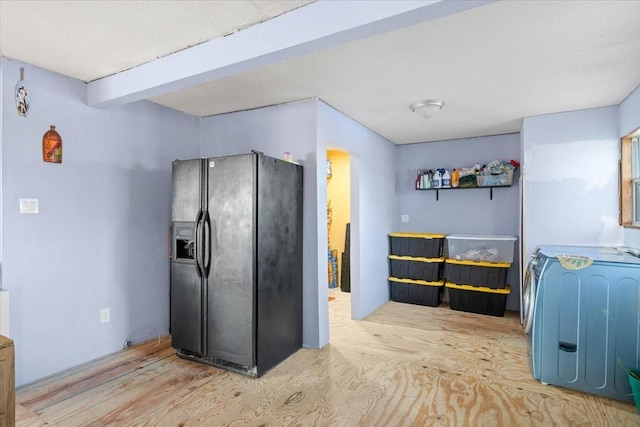 kitchen with black fridge with ice dispenser, beamed ceiling, and light hardwood / wood-style flooring