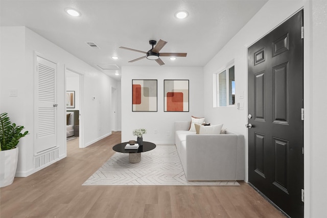 living room featuring ceiling fan and light hardwood / wood-style flooring