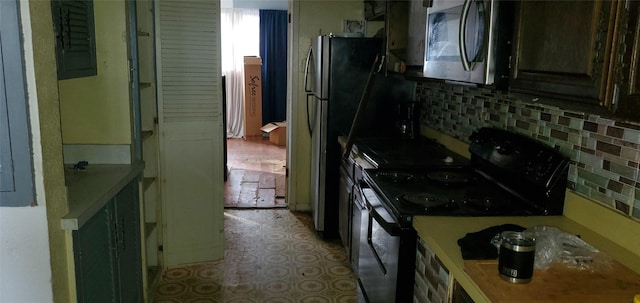 kitchen featuring backsplash and black range with electric cooktop