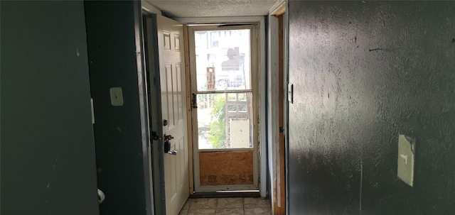 entryway featuring a textured ceiling and a wealth of natural light