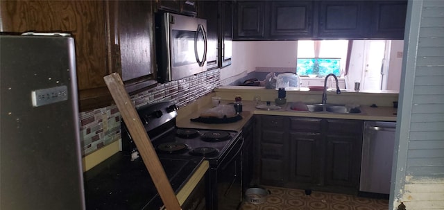 kitchen with stainless steel appliances, dark brown cabinets, and sink